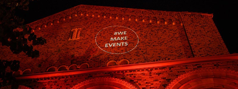 front of laxson auditorium with red lights and words that say we make events