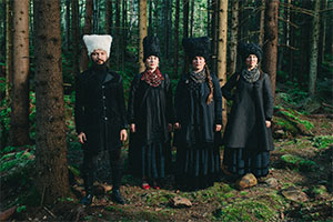 DakhaBrakha members standing in a forest