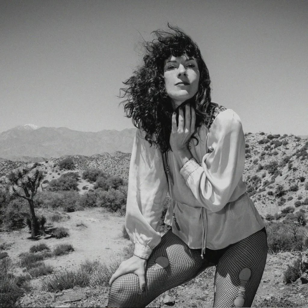 Woman in fishnets standing in the desert