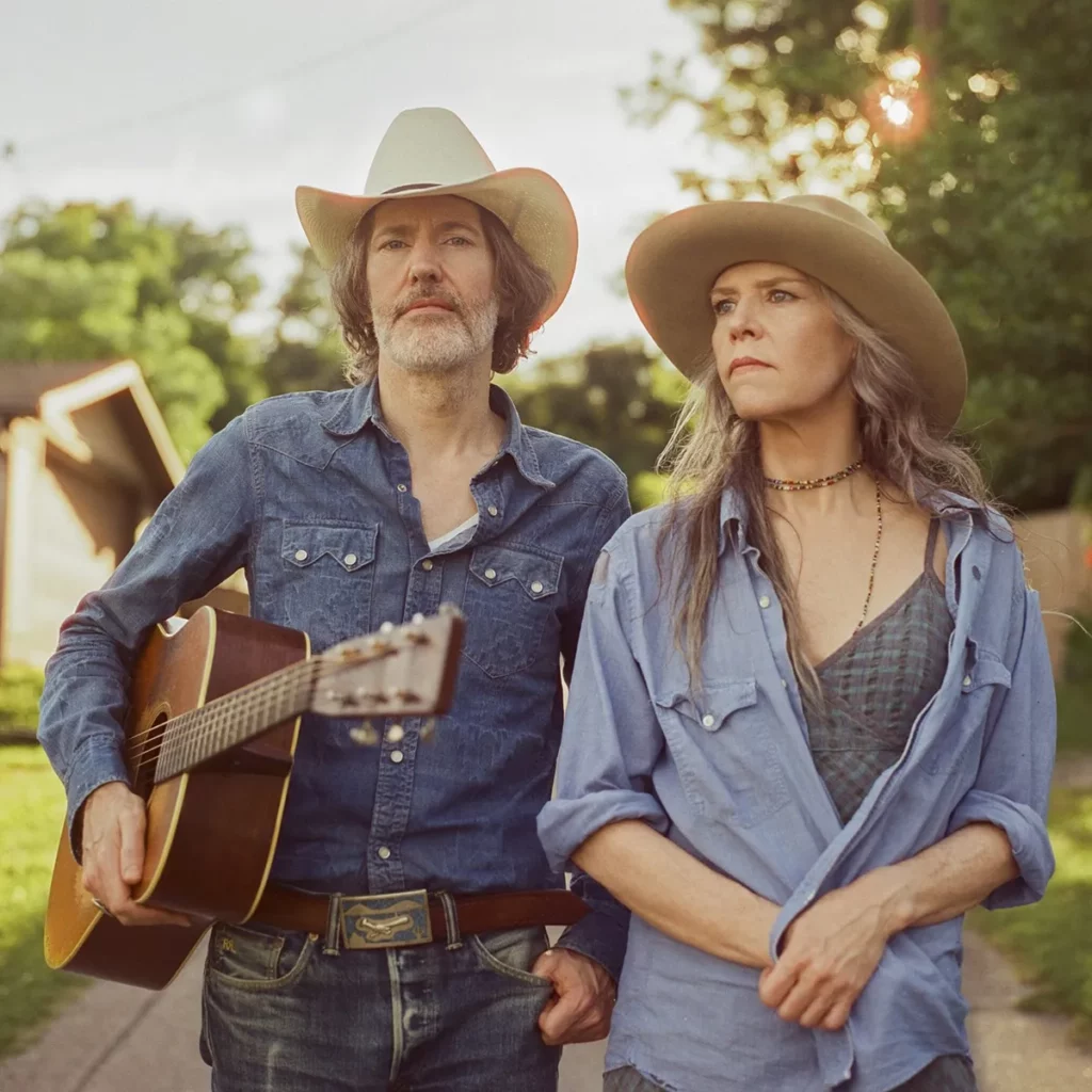 Musicians David Rawlings and Gillian Welch posing in Western wear.