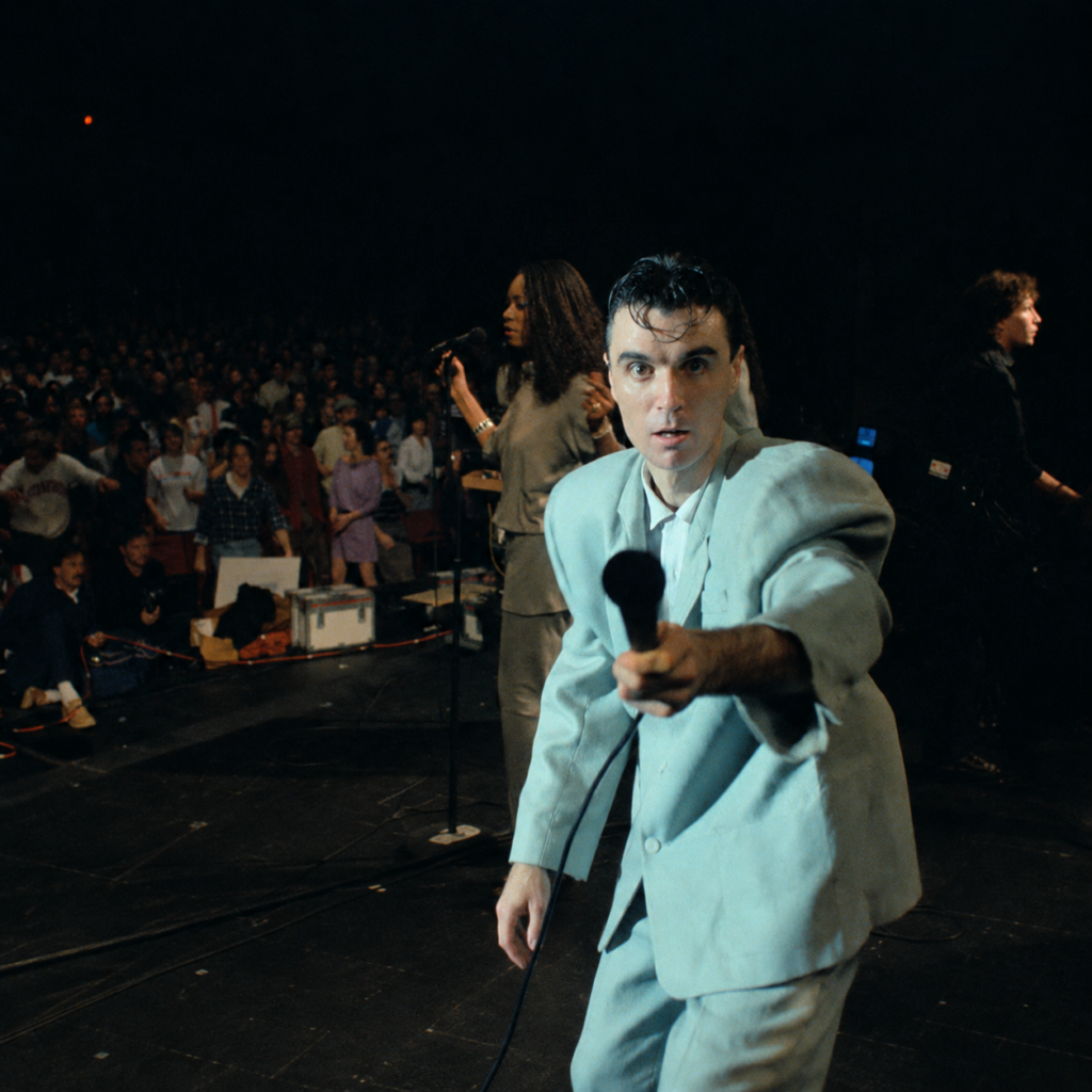Talking heads lead singer reaching out with a microphone